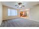 Open living room with view of kitchen and ceiling fan at 9494 Stillwater Bend Ln, Las Vegas, NV 89178