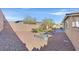 Private backyard with gravel landscaping, fire pit, and brick-paved patio at 10330 Glacier Mist Ave, Las Vegas, NV 89149