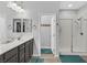 Bright bathroom with a double sink vanity, a framed mirror, and a glass-enclosed shower at 10330 Glacier Mist Ave, Las Vegas, NV 89149