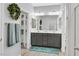 Modern bathroom featuring dual sinks, stylish fixtures, and a decorative wreath at 10330 Glacier Mist Ave, Las Vegas, NV 89149