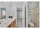 Bathroom featuring a shower-tub combo with a autumn-themed shower curtain, and vanity with ample lighting at 10330 Glacier Mist Ave, Las Vegas, NV 89149