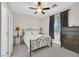 Cozy bedroom with a ceiling fan, carpeted flooring, a wrought iron bed frame, and neutral walls at 10330 Glacier Mist Ave, Las Vegas, NV 89149