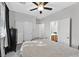 Bright bedroom featuring carpeted floors, a ceiling fan, and access to an ensuite bathroom at 10330 Glacier Mist Ave, Las Vegas, NV 89149