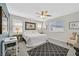 Main bedroom with large bed, ceiling fan, and sitting area at 10330 Glacier Mist Ave, Las Vegas, NV 89149