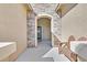 Inviting front entrance with a stone archway, decorative bench, and a view of the modern door, creating a welcoming ambiance at 10330 Glacier Mist Ave, Las Vegas, NV 89149