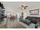 Open-concept space featuring dark wood floors, a comfortable leather sectional, and seamless flow to the dining area at 10330 Glacier Mist Ave, Las Vegas, NV 89149