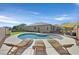 Relaxing pool area with lounge chairs and shade sail at 10330 Glacier Mist Ave, Las Vegas, NV 89149