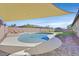 Inviting kidney-shaped pool with a patio and shade sail at 10330 Glacier Mist Ave, Las Vegas, NV 89149