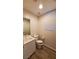 Modern bathroom with white vanity, toilet and wood-look tile floor at 11251 Hidden Peak Ave # 212, Las Vegas, NV 89135