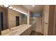 Modern bathroom with double vanity, large mirror, and walk-in shower at 11251 Hidden Peak Ave # 212, Las Vegas, NV 89135