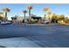 Modern community building with palm trees and parking lot at 11251 Hidden Peak Ave # 212, Las Vegas, NV 89135