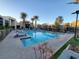 Inviting community pool with lounge chairs and palm trees at 11251 Hidden Peak Ave # 212, Las Vegas, NV 89135