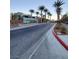 Community entrance with palm trees and modern signage at 11251 Hidden Peak Ave # 212, Las Vegas, NV 89135