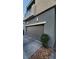 Attached garage with modern door and landscaping at 11251 Hidden Peak Ave # 212, Las Vegas, NV 89135