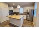 Modern kitchen with island, stainless steel appliances, and wood flooring at 11251 Hidden Peak Ave # 212, Las Vegas, NV 89135