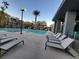 Community pool with plenty of lounge chairs for relaxing at 11251 Hidden Peak Ave # 212, Las Vegas, NV 89135