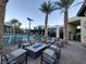 Community pool area with fire pit and lounge chairs at 11251 Hidden Peak Ave # 212, Las Vegas, NV 89135