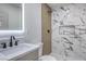 Elegant bathroom with marble shower, modern vanity, and LED mirror at 133 Dogwood St, Henderson, NV 89015