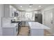 Modern kitchen with white cabinets, quartz countertops, and a large island at 133 Dogwood St, Henderson, NV 89015