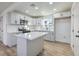 Modern kitchen with white cabinets, quartz countertops and island at 133 Dogwood St, Henderson, NV 89015