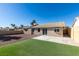 Large backyard with artificial turf, patio, and a view of the house at 1850 Banaba Ln, Las Vegas, NV 89156