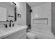 Modern bathroom with white vanity, black matte fixtures, and marble shower at 1850 Banaba Ln, Las Vegas, NV 89156