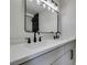 Modern bathroom with double vanity, black matte fixtures, and large mirror at 1850 Banaba Ln, Las Vegas, NV 89156