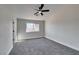 Spacious bedroom with ceiling fan and grey carpet at 1850 Banaba Ln, Las Vegas, NV 89156