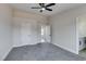 Bright bedroom with grey carpet, ceiling fan and access to other rooms at 1850 Banaba Ln, Las Vegas, NV 89156