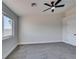 Bright bedroom with ceiling fan and large window at 1850 Banaba Ln, Las Vegas, NV 89156