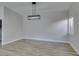 Bright dining room with wood-look floors and modern light fixture at 1850 Banaba Ln, Las Vegas, NV 89156