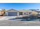 Single story home with gray garage door and landscaping at 1850 Banaba Ln, Las Vegas, NV 89156