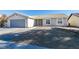 Single story home with gray garage door and landscaping at 1850 Banaba Ln, Las Vegas, NV 89156