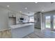 Modern kitchen with island, stainless steel appliances, and white cabinets at 1850 Banaba Ln, Las Vegas, NV 89156