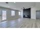 Bright living room with fireplace, wood-look floors, and ceiling fan at 1850 Banaba Ln, Las Vegas, NV 89156