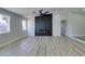 Light and bright living room features a modern fireplace and wood-look floors at 1850 Banaba Ln, Las Vegas, NV 89156