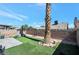 Landscaped backyard with artificial turf and a small water fountain at 1861 Ridgefield Dr, Las Vegas, NV 89108