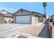 Single-story house with a white garage door and gravel driveway at 1861 Ridgefield Dr, Las Vegas, NV 89108