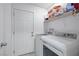 Laundry room with washer, dryer, and extra storage shelving at 1861 Ridgefield Dr, Las Vegas, NV 89108