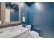 Modern powder room with dark blue walls and white vanity at 1926 Dresden Ct, Henderson, NV 89014