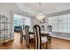 Formal dining room featuring a glass-top table and modern chandelier at 1926 Dresden Ct, Henderson, NV 89014