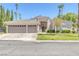 Single-story house with two-car garage and grassy front yard at 1926 Dresden Ct, Henderson, NV 89014