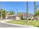 Single story house with a three car garage and palm trees at 1926 Dresden Ct, Henderson, NV 89014