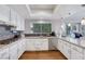 Modern kitchen with white cabinets, granite countertops and island at 1926 Dresden Ct, Henderson, NV 89014