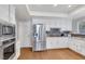 Modern kitchen with white cabinets, granite counters and stainless steel appliances at 1926 Dresden Ct, Henderson, NV 89014