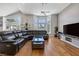 Living room with hardwood floors, sectional sofa, and large windows at 1926 Dresden Ct, Henderson, NV 89014