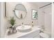 Bathroom with a stylish vessel sink, a round mirror, and decorative decor at 1963 Scimitar Dr # 0, Henderson, NV 89014