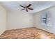 Empty bedroom with laminate flooring, a ceiling fan and a window with blinds at 1963 Scimitar Dr # 0, Henderson, NV 89014