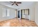 Bright bedroom with hardwood floors, closet organizers, and a ceiling fan at 1963 Scimitar Dr # 0, Henderson, NV 89014