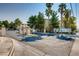 Community entrance sign and gate surrounded by mature palm trees and lush landscaping at 1963 Scimitar Dr # 0, Henderson, NV 89014